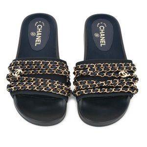CHANEL navy slides gold chain and CC charms.